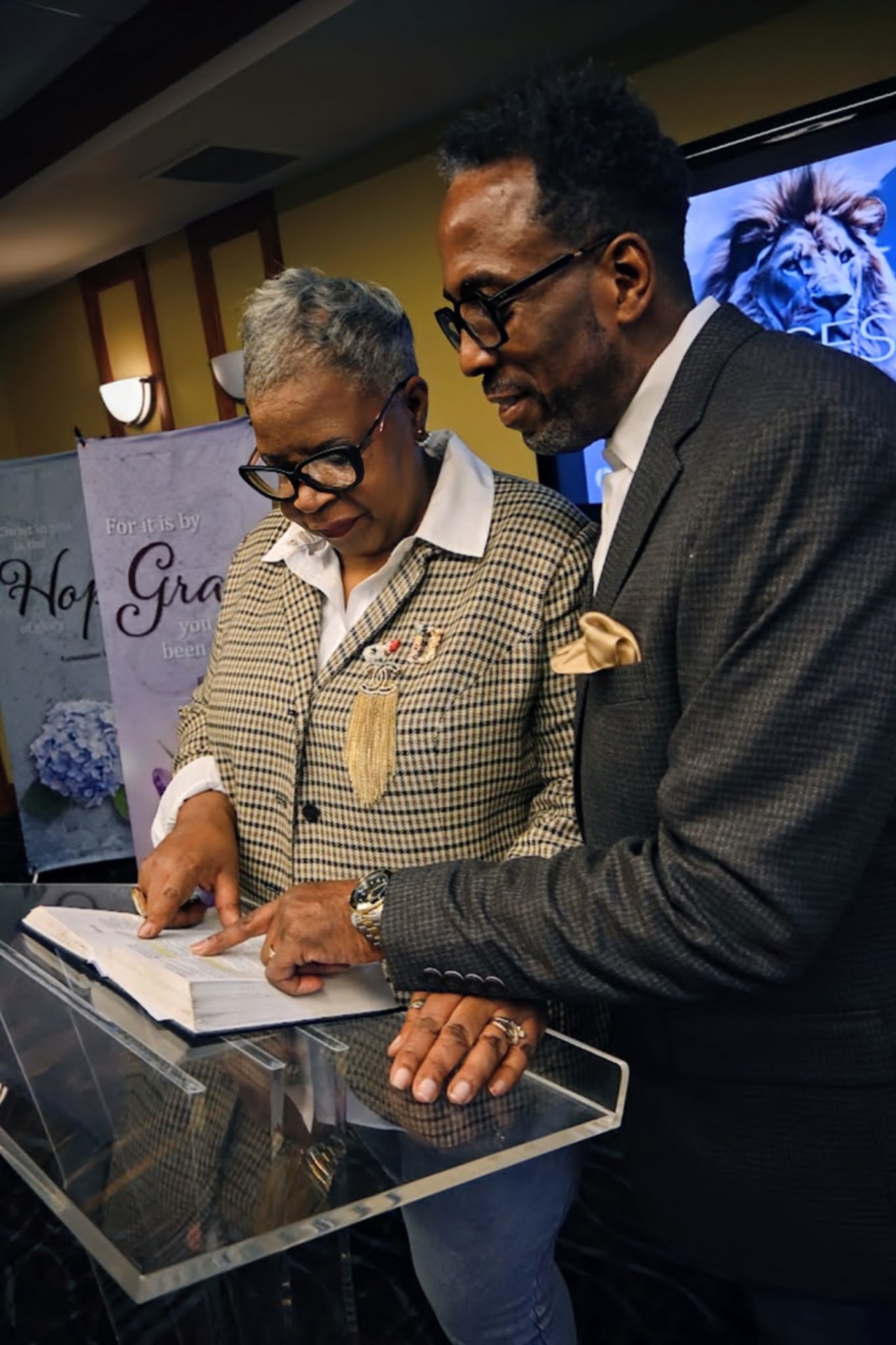 Pastor Glenn Bond praying with a member of the congregation during a service